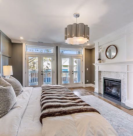 Bedroom with fireplace and glass doors