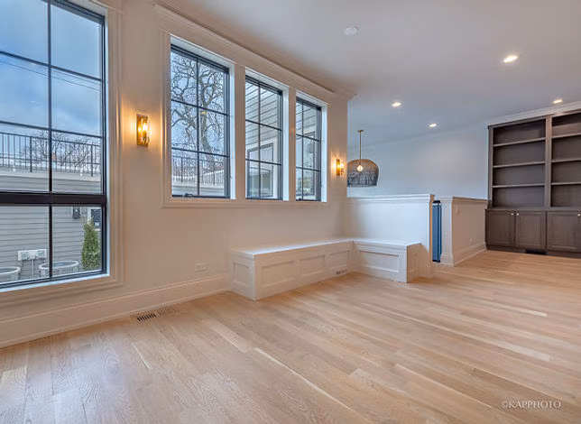 Bright landing with window bench and built-in shelving