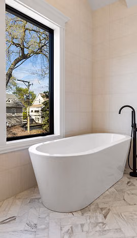 Bathroom with freestanding tub and window view