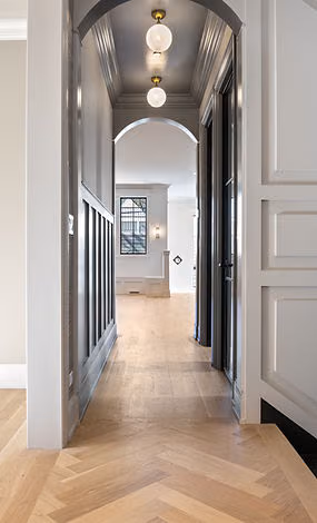 Herringbone hallway with arched doorways in a Bellevue home