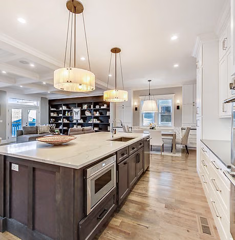 Open kitchen with dark island and pendant lights