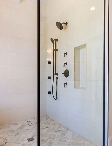 Walk-in shower with black fixtures